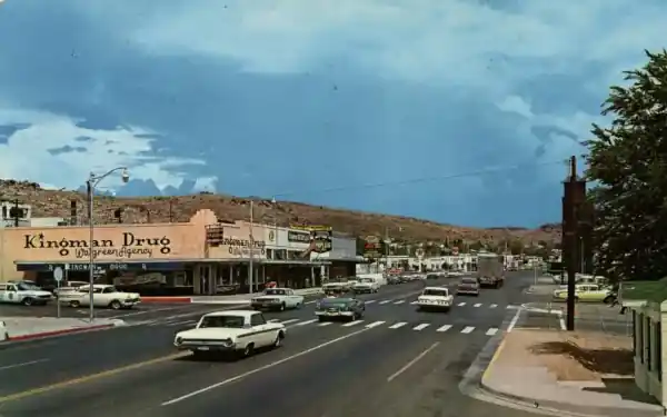1960s view Texaco gas station c.1960s color postcard traffic on US 66, buildings and Texaco sign