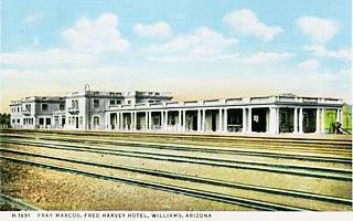 1920s color postcard long stately bldg w/columns & arches by railroad tracks