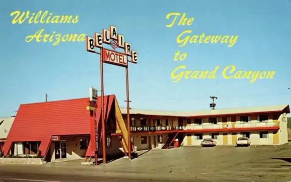 1960s postcard 2-story L-shaped layout, steep roofed office, neon sign