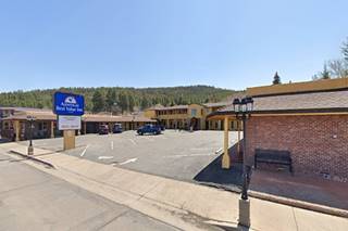 modern motel, forested hill behind