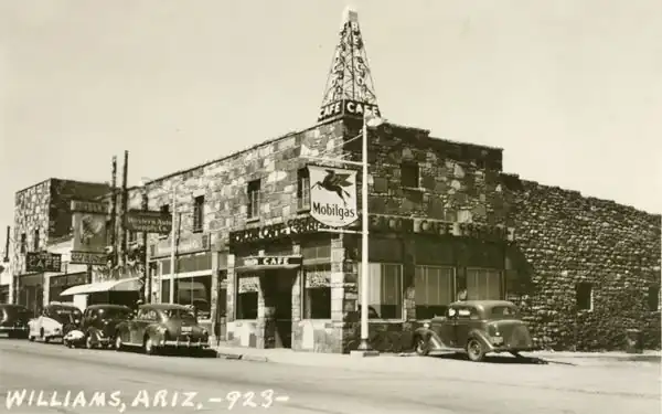 black & white photo, irreglular flagstone 2-story bldg, 1940s