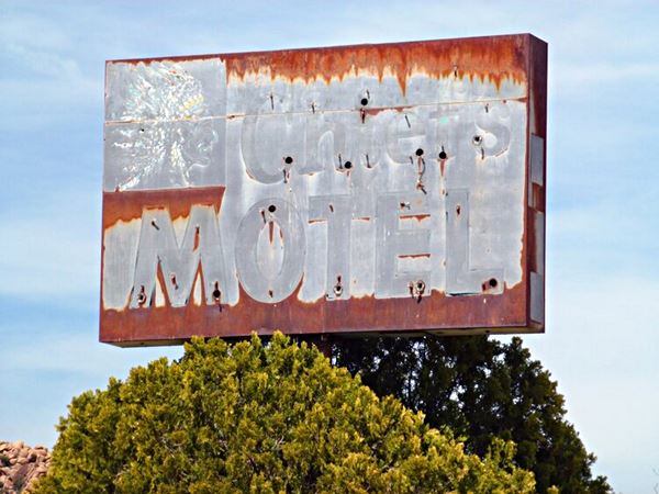 rusting faded Chief’s Motel neon sign