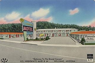 color postcard 19650s, neon sign, motel, forested hill behind