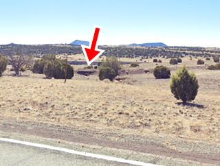 Old Route 66 culvert and enbankment east of Seligman AZ an old concrete culvert and highway embankment in the distance seen from current US66, desert and stunted trees