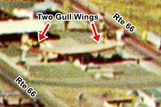 zoom of late 1950s aerial view, 2 two gull wings visible on Phillips 66 station