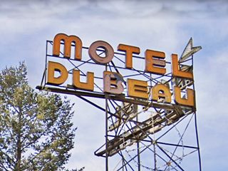 Dubeau motel neon sign YW letters of a motel neon sign atop a tower