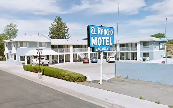 2-story motel with blue neon sign-white letters
