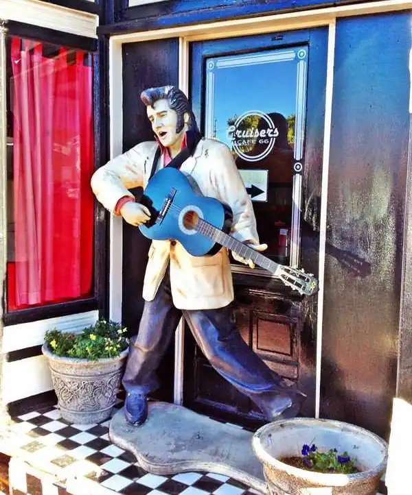 life size statue of Elvis Presley playing his guitar