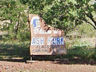 flagstone capital marker, Ash Fork AZ flagstone painted with words "Welcome to Ash Fork Flagstone Capital"