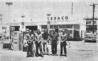 1963 black white men by Texaco gas station