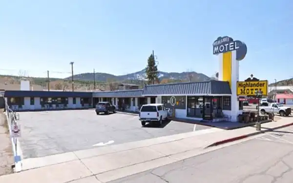 motel with flat roof, metal mansards, corner office, tower w/neon sign on top