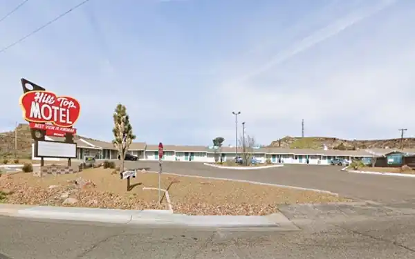 Hill Top Motel today cars, a red neon sign, units of Motel