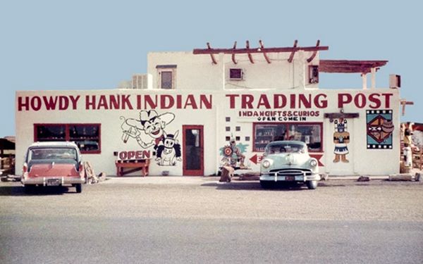 1950s photo, the trading post and two cars parked in front