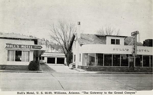 Vintage black and white postcard of motel seen from Route 66