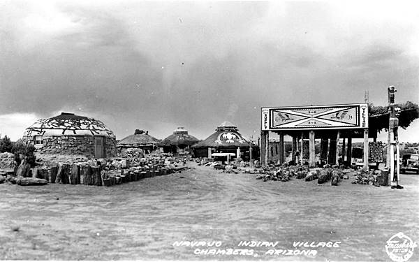 hogans, 1930s car and stalls at a trading post in a vintage black and white postcard