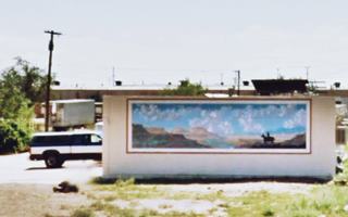 mural of a rider in the wilderness on a wall facing US66