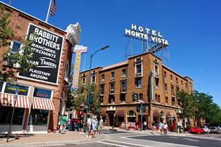 Monte Vista Hotel now A present view of the brick facade and neon sign of the classic Monte Vista Hotel