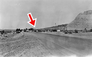 1938 Port of Entry at Lupton AZ black and white picture looking west along Route 66, right side: cliffs, buildings, trees
