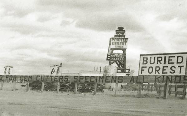 black and white photo of a trading post, a tower, signs, Shamrock gas station