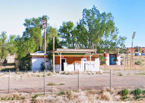former gas station, boarded and vacant, trees, and Route 66