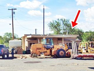 Sinclair gas station, Ash Fork Route 66 gas station behind heavy road building equipment, office and canopy visible