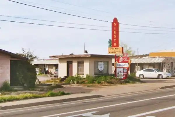 Siesta Motel Now small office, classic red vertical neon sign