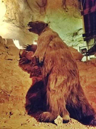 Sloth in the Grand Canyon Caverns life sized replica of a giant sloth, furry statue with lit up cavern walls behind it