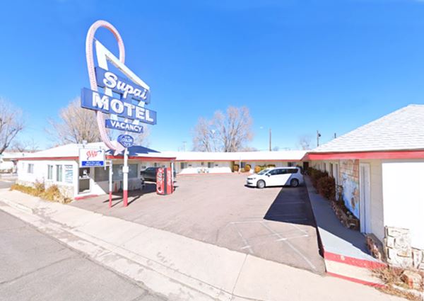 vintage neon sign, U-shaped layout on a single floor, gable roof motel