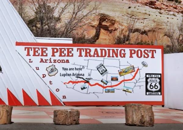 Tepee Trading Post map of US66, Lupton large map of Route 66 painted on a white wall, tepee wall on the left, cliff behin