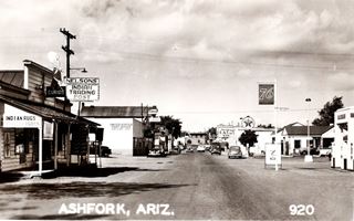 looking east along Lewis Ave in 1940s, Ash Fork AZ looking east along Lewis Ave Union76 station on the right, followed by old Texaco, cars and stores black and white photo taken in 1940s