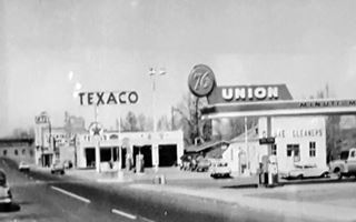 looking east along Lewis Ave in 1950s, Ash Fork AZ looking east along Lewis Ave Union76 station on the right, followed by old Texaco, cars and stores black and white photo taken in 1950s
