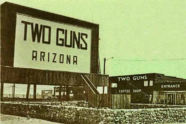 Two Guns Texaco, in a 1940s black and white postcard, car, sign, building, and now, razed only two stone columns stand