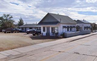 gable roof buildings facing US66 and more units at the rear with a central courtyard