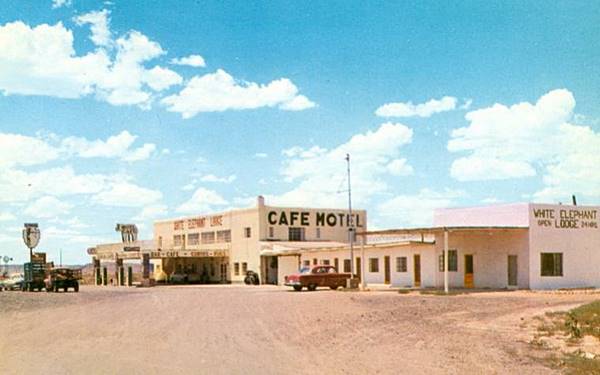 color postcard, trading post motel, gas station and cars, 2 story block shaped building