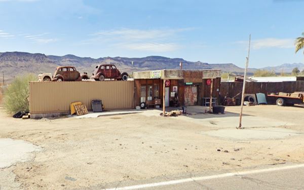 old gas station, flat canopy and two 1940s cars on a 20-foot container