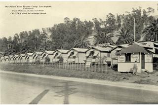 The Palms tourist camp c.1932 Los Angeles, Route 66 black and white. c1932, man by office on the right signs indicate an auto tourist camp cabins lined up towards the left