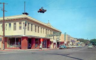 1950s D and 7th streets Victorville CA corner of two streets in the 1950s, cars, hotels, trees, traffic light