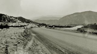 AT&SF viaduct in 1930 US 66, Cajon Pass Black and white 1930, US66 passes under a Railway viaduct, arid scenery, hills