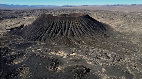 volcano at Amboy CA black cindercone of a volcano arising out of the desert and black lava flows