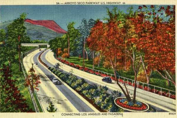 Arroyo Seco Pkwy 1940 postcard Los Angeles CA Route 66 color linnen postcard cars drive along divided highway that curves. Bridge spans it, trees and flowers and hills beyond