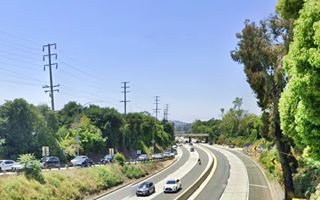 Arroyo Seco Parkway nowadays color, contemporary, cars driving along freeway, vegetation, off ramps, overpass in the distance