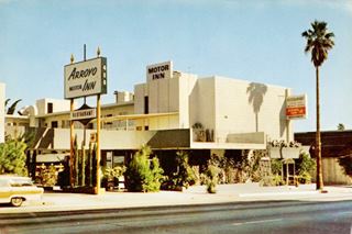motel, a 3 story complex with flat box shaped look. Neon sign on street, reads ARROYO MOTOR INN photo postcard. Car parked