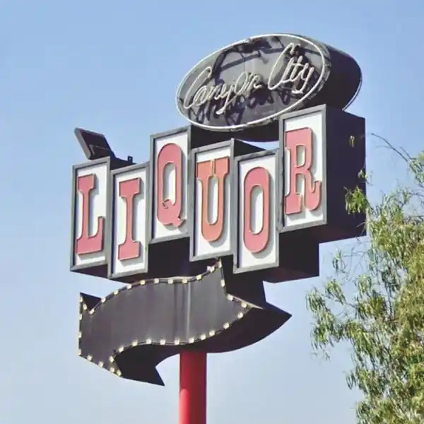 Azusa Liquor Store neon sign, US66 1950s Liquor Store neon sign with circle, black arrow, white boxes; red letters spell LIQUOR