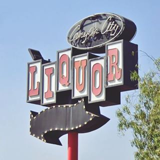 Azusa Liquor Store neon sign, US66 1950s Liquor Store neon sign with circle, black arrow, and white boxes with red letters spelling LIQUOR