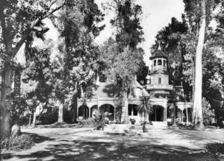 Lucky Baldwin's Queen Anne cottage, Arcadia CA black and white, forested garden surrounds 2 story Queen Anne building
