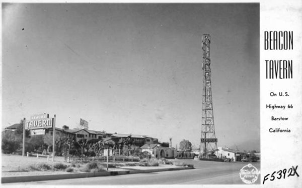 Beacon Tavern, 1944, Barstow US 66 by B. Frasher black and white, 1944. Route 66 right, left two-story semicircular building Spanish style, tiled gabled roofs, tall tower RICHFIELD written on it