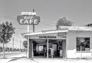 Blvd Cafe Duarte CA black and white photo 1980s small building neon sign reads BLVD CAFE, some tables inside, Coke and Hamburger signs, Route 66 on the left