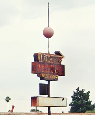 1950s rusting faded Cajon Motel neon sign US 66 rusting neon sign with a ball atop a pointed tip