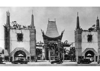 Chinese Theater in 1927, Hollywood CA black and white 1927, cars parked by a pagoda shaped theater with palm trees
