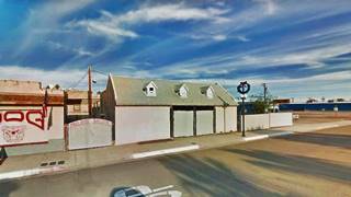 gable roof bldg.former motel, bar to the left, US 66 in front